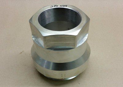 a single, metallic industrial component with a silver finish against a neutral background. It features an octagonal top with internal threading and a cylindrical base with two distinct sections, indicating it is a precision-engineered part for assembly or manufacturing processes.