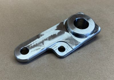 a bespoke metal part with a polished surface, designed to meet the specific needs of a customer. This component demonstrates the company's capability to craft intricate, custom-made pieces tailored to individual requirements, showcasing their expertise in precision manufacturing and their commitment to deliver made-to-order solutions.