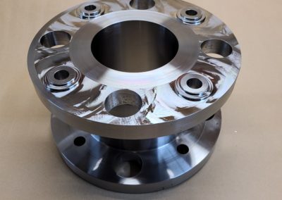 Thomas Coupling, a specific type of industrial coupling component. It is a robust, multi-part metal device with a glossy finish, featuring a central hole and several smaller bolt holes around its flange for securing it to other machinery parts.